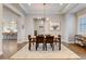 Elegant dining room featuring a modern chandelier, light grey walls, and an open concept design at 8000 Gore Creek Ln, Littleton, CO 80125