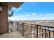 Balcony with black metal railing overlooking a stunning city view under a bright blue sky at 2990 E 17Th Ave # 1102, Denver, CO 80206