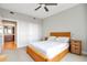 Cozy bedroom with wicker platform bed, soft carpet, and an ensuite bathroom visible through the doorway at 2990 E 17Th Ave # 1102, Denver, CO 80206