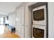 Convenient laundry area with a stacked washer and dryer unit at 2990 E 17Th Ave # 1102, Denver, CO 80206