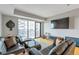 Bright living room featuring hardwood floors, sliding doors to balcony, and comfortable furniture at 2990 E 17Th Ave # 1102, Denver, CO 80206
