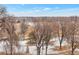 Beautiful neighborhood view with mature trees and a park in the distance at 2990 E 17Th Ave # 1102, Denver, CO 80206