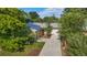 Aerial view of brick home with solar panels, manicured lawn, long driveway and attached garage at 216 Hemlock, Broomfield, CO 80020