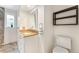 Bathroom with white vanity, granite countertop and a view into the shower at 216 Hemlock, Broomfield, CO 80020