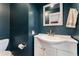 Bathroom with blue walls, a white vanity, toilet, and chrome fixtures at 216 Hemlock, Broomfield, CO 80020
