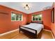 Bedroom with hardwood floors, two windows, and neutral colored walls at 216 Hemlock, Broomfield, CO 80020