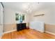 Bedroom featuring hardwood floors, a dark dresser, and ample natural light from the window at 216 Hemlock, Broomfield, CO 80020