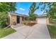 Charming brick home featuring a long driveway, attached garage, and well-manicured front yard at 216 Hemlock, Broomfield, CO 80020