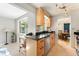 Open kitchen with natural wood cabinets, granite countertops, and modern stainless steel appliances at 216 Hemlock, Broomfield, CO 80020