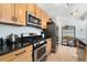 Well-lit kitchen featuring granite countertops, stainless steel appliances, and wooden cabinetry at 216 Hemlock, Broomfield, CO 80020