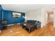 Comfortable living room featuring hardwood floors, a gray sectional, and a mounted television at 216 Hemlock, Broomfield, CO 80020
