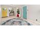 Bright living room with yellow and blue doors, and a stylish rug in the center at 216 Hemlock, Broomfield, CO 80020