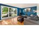 Comfortable living room with hardwood floors, a large window, and a cozy gray sectional sofa at 216 Hemlock, Broomfield, CO 80020