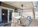 Covered back porch with comfortable seating and view of a well-maintained backyard at 8796 E 150Th Ct, Thornton, CO 80602