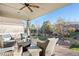 Inviting back porch area with comfortable seating and a serene backyard view at 8796 E 150Th Ct, Thornton, CO 80602