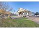 Spacious backyard featuring a covered porch with outdoor seating, a well-maintained lawn, and mature trees at 8796 E 150Th Ct, Thornton, CO 80602