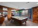 Finished basement with a pool table, exposed beams, and adjacent sitting area at 8796 E 150Th Ct, Thornton, CO 80602