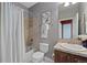 Neutral colored bathroom featuring a shower over the bath, a toilet, and a sink with traditional style fixtures at 8796 E 150Th Ct, Thornton, CO 80602