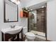 Stylish bathroom featuring a glass-enclosed shower and a modern vanity sink at 8796 E 150Th Ct, Thornton, CO 80602