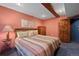 Bedroom with wood accents, closet, and natural light from the window at 8796 E 150Th Ct, Thornton, CO 80602