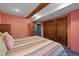 Cozy bedroom with wood accents and ample storage space in closet at 8796 E 150Th Ct, Thornton, CO 80602