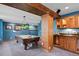 Basement billiards room with a pool table, wet bar, and dark blue walls creating an inviting space for entertainment at 8796 E 150Th Ct, Thornton, CO 80602