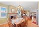 Cozy dining area with fireplace, chandelier lighting, and beautiful hardwood floors at 8796 E 150Th Ct, Thornton, CO 80602