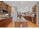 Granite island kitchen with stainless appliances and hardwood floors, ideal for entertaining at 8796 E 150Th Ct, Thornton, CO 80602