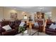 Open concept living room with hardwood floors and view to the kitchen at 8796 E 150Th Ct, Thornton, CO 80602