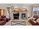Comfortable living room featuring a stone fireplace and large windows at 8796 E 150Th Ct, Thornton, CO 80602