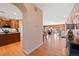 Spacious open floor plan featuring hardwood floors, kitchen, and dining area at 8796 E 150Th Ct, Thornton, CO 80602