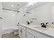 Well-lit bathroom featuring double sinks, quartz countertops, and a glass-enclosed shower at 8205 Cokedale Cir, Littleton, CO 80125