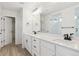 Modern bathroom featuring double sinks, quartz countertops, sleek black hardware, and a glass-enclosed shower at 8205 Cokedale Cir, Littleton, CO 80125