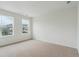 Bright bedroom featuring neutral carpeting, white walls, and plenty of natural light from two large windows at 8205 Cokedale Cir, Littleton, CO 80125