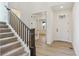 Inviting entryway with hardwood floors and a staircase leading to the upper level at 8205 Cokedale Cir, Littleton, CO 80125
