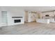 Open-concept living space with modern finishes, fireplace, and ample lighting at 8205 Cokedale Cir, Littleton, CO 80125