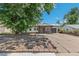 Quaint single-story home featuring stone accents, a well-manicured lawn and a driveway leading to a one-car garage at 1680 S Patton Ct, Denver, CO 80219