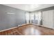 Bright living room featuring hardwood floors, neutral walls, and natural light, creating a comfortable atmosphere at 1680 S Patton Ct, Denver, CO 80219