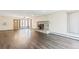 Inviting living room featuring hardwood floors, large windows, ceiling fan, and wood burning stove fireplace at 1680 S Patton Ct, Denver, CO 80219