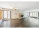 Spacious living room boasts hardwood floors, large windows, ceiling fan, and charming fireplace at 1680 S Patton Ct, Denver, CO 80219