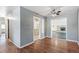 Open living room featuring hardwood floors, neutral walls, and view into dining area, perfect for entertaining guests at 1680 S Patton Ct, Denver, CO 80219