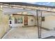 Covered patio with concrete floor offers outdoor space for relaxing or entertaining near the back entrance of the home at 1680 S Patton Ct, Denver, CO 80219