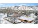 Snow covered aerial view of home and surrounding landscape with mountain backdrop at 1400 Golden Cir # 202, Golden, CO 80401