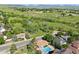 Aerial view of a house with a pool and large backyard overlooking mountain range at 310 S Alkire St, Lakewood, CO 80228