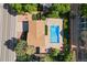 Aerial view of a home with a private backyard pool, a fire pit, and mature trees at 310 S Alkire St, Lakewood, CO 80228