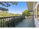 Charming blue balcony with wooden railings, providing a relaxing outdoor space with a scenic neighborhood view at 310 S Alkire St, Lakewood, CO 80228