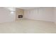 Spacious basement featuring modern fireplace, brick wall, and light laminate floors at 310 S Alkire St, Lakewood, CO 80228