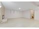 Spacious basement featuring modern fireplace, brick wall, and light laminate floors at 310 S Alkire St, Lakewood, CO 80228