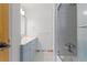 Bright bathroom with a shower over the tub and vanity with lots of storage at 310 S Alkire St, Lakewood, CO 80228