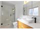Stylish bathroom featuring a glass-enclosed shower and modern sink at 310 S Alkire St, Lakewood, CO 80228